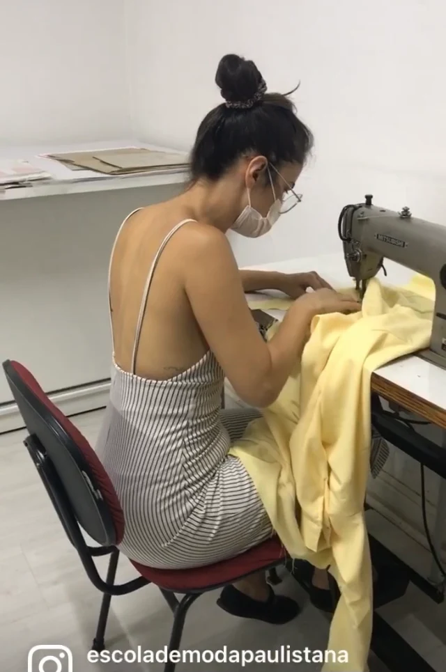 Aluna realizando costura em máquina durante aula prática de costura